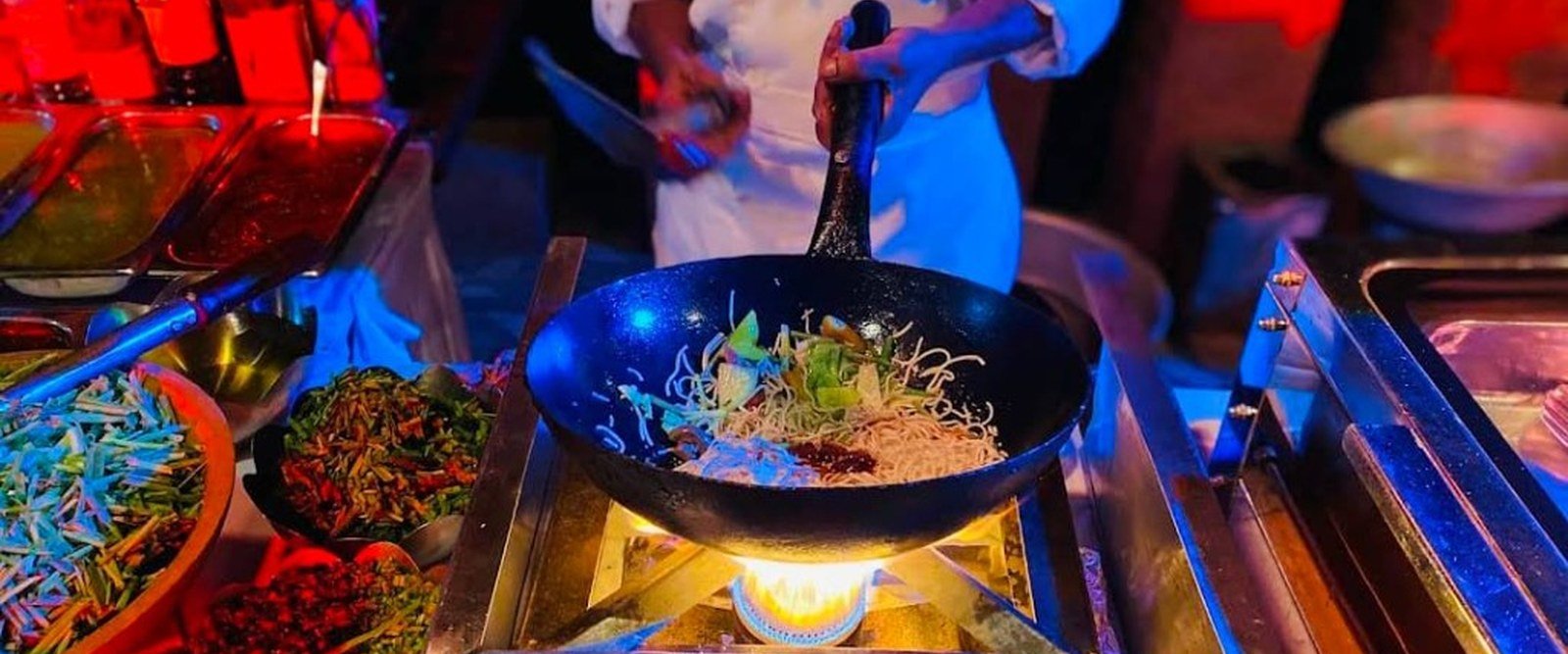 Live wok and stir-fry station with chef cooking at an event — Abhijat Catering live counters
