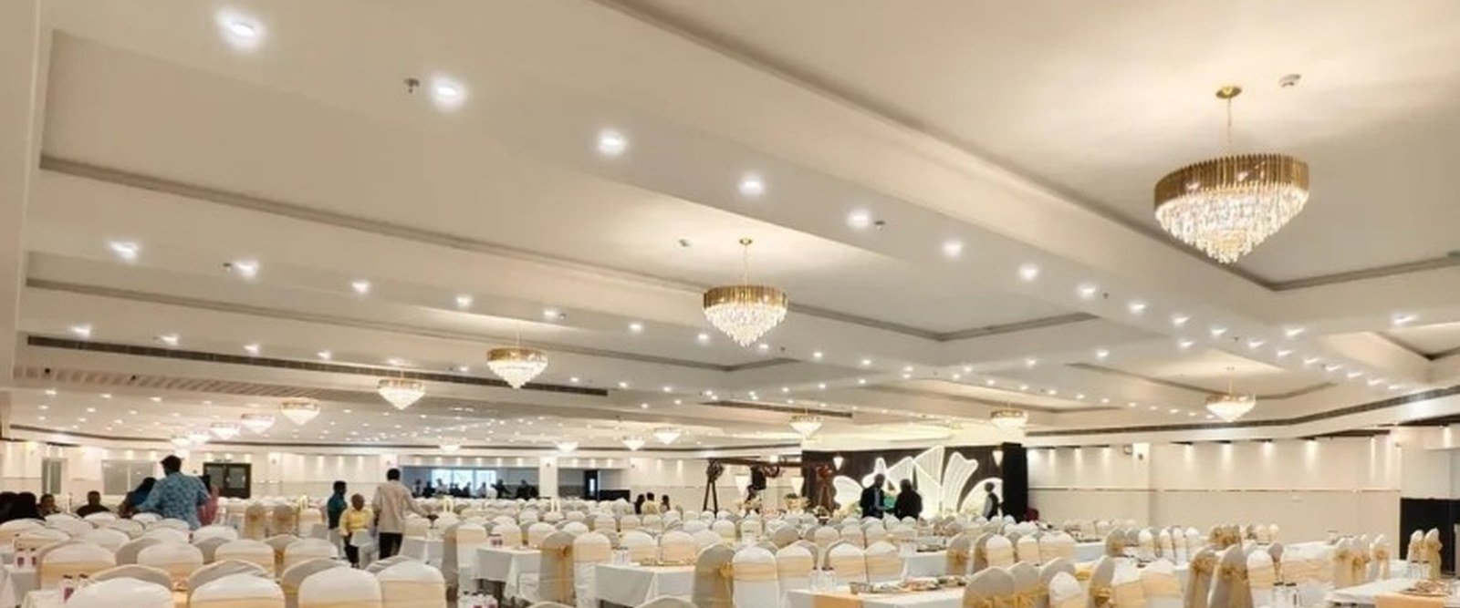 Large banquet hall set for corporate conference catering with rows of tables and chandeliers — Abhijat Catering Kolkata and West Bengal