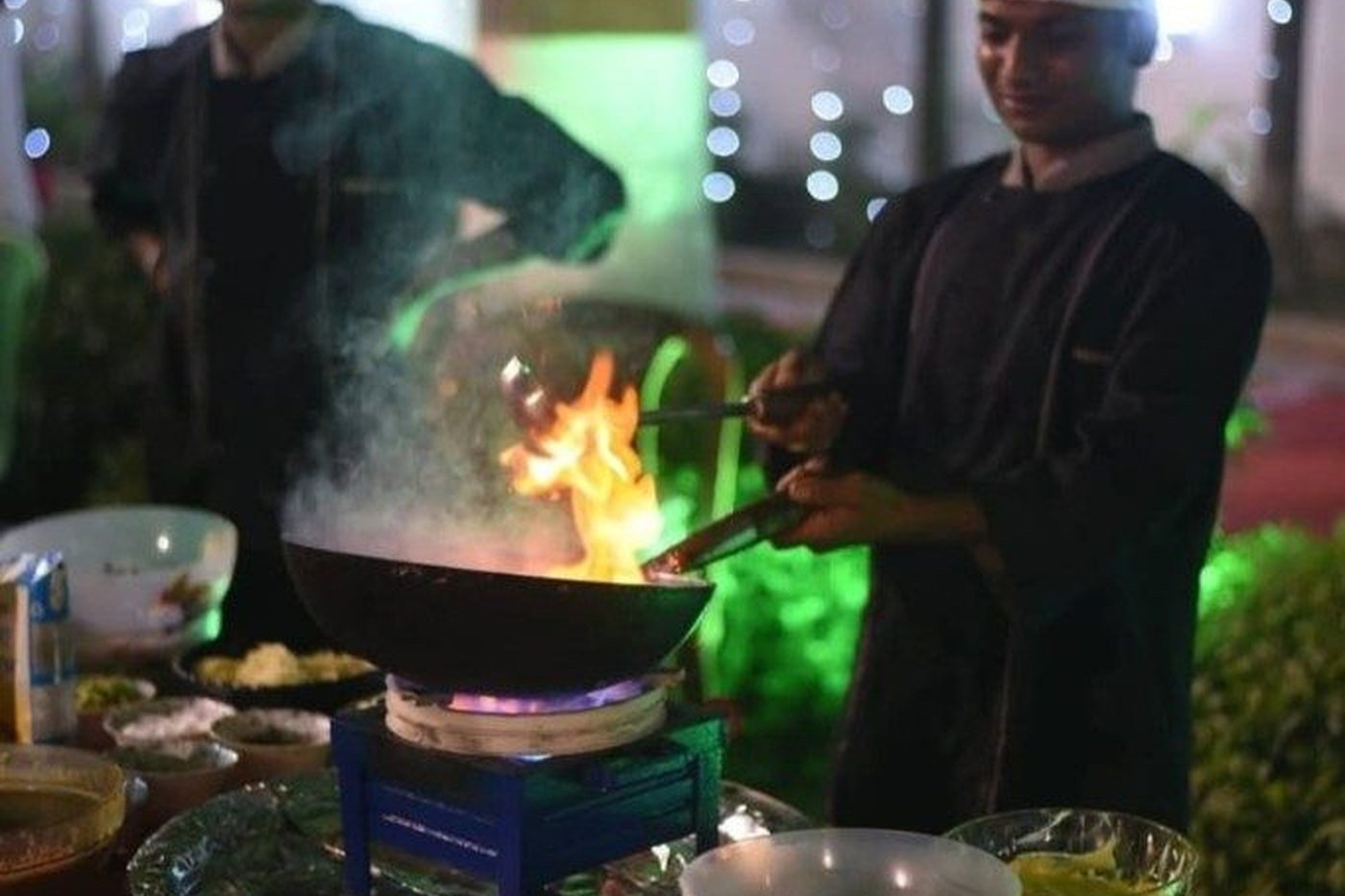 Live wok and flambe counter at an outdoor sports event or family day in West Bengal